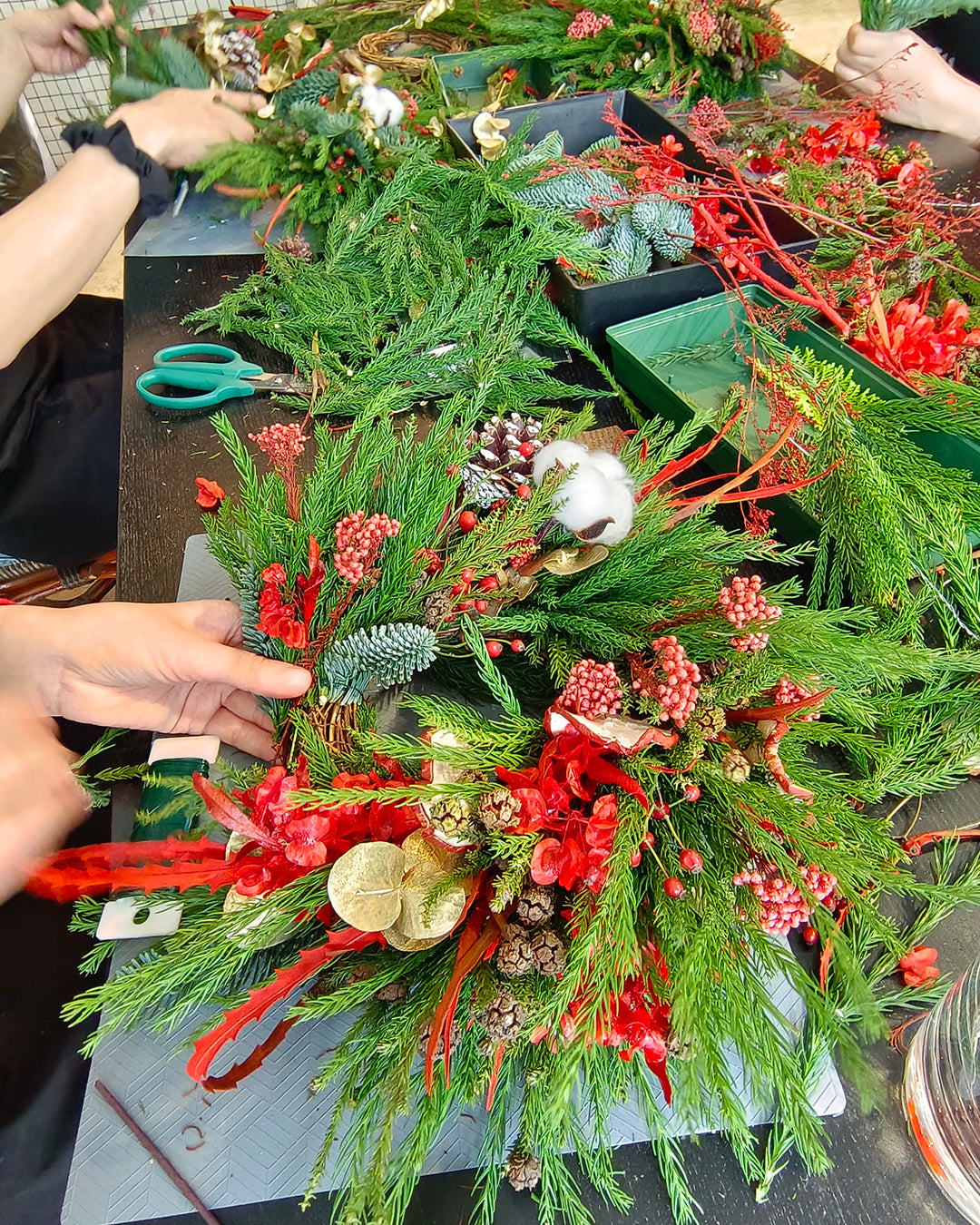 Participants at our Xmas Workshop learning how to make their own wreath.